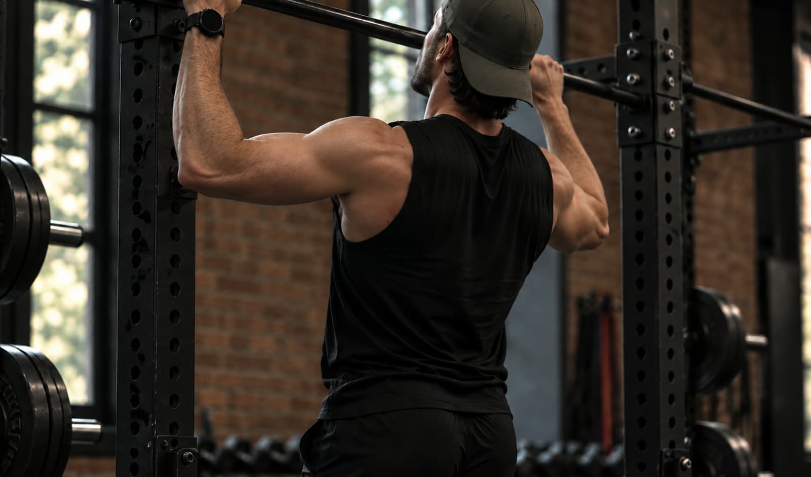 A member pulling up on a bar in a rack